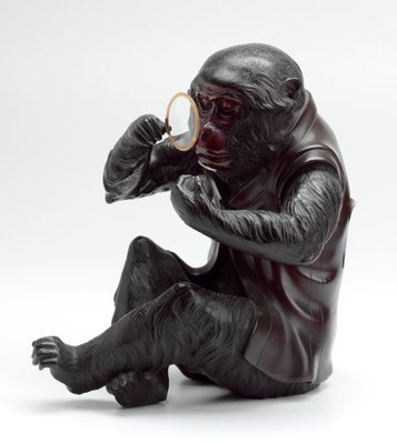 Alternate image of Monkey wearing a waistcoat and using an eyeglass to examine a peach by Meiji export ware