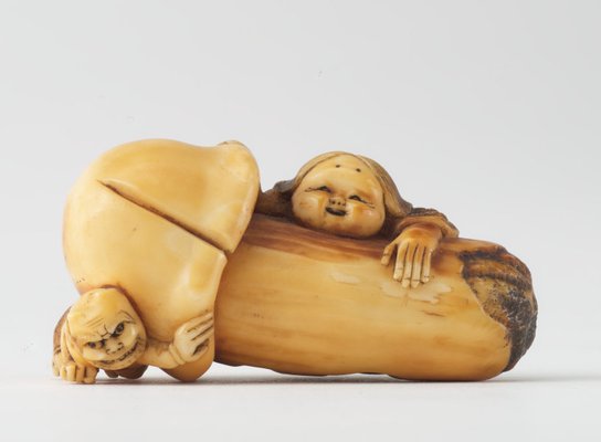 Alternate image of Netsuke in the form of a mushroom with 'okame' leaning against it and 'oni' crouching under it by 