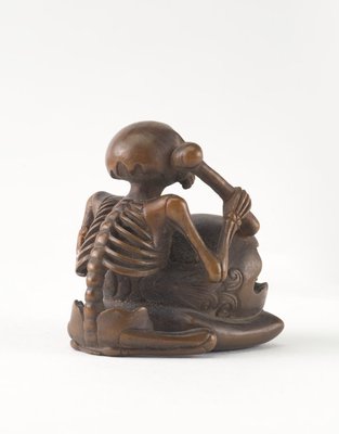 Alternate image of Netsuke in the form of a seated skeleton hitting a 'wooden fish' bell ('mokugyo') by 